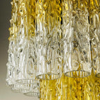 Close-up of a decorative chandelier with clear and gold glass elements.