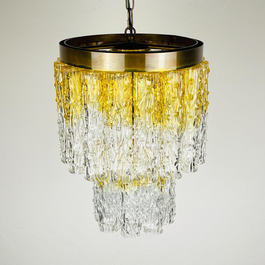 Chandelier with gold and clear glass design on a light gray background