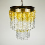 Chandelier with gold and clear glass design on a light gray background