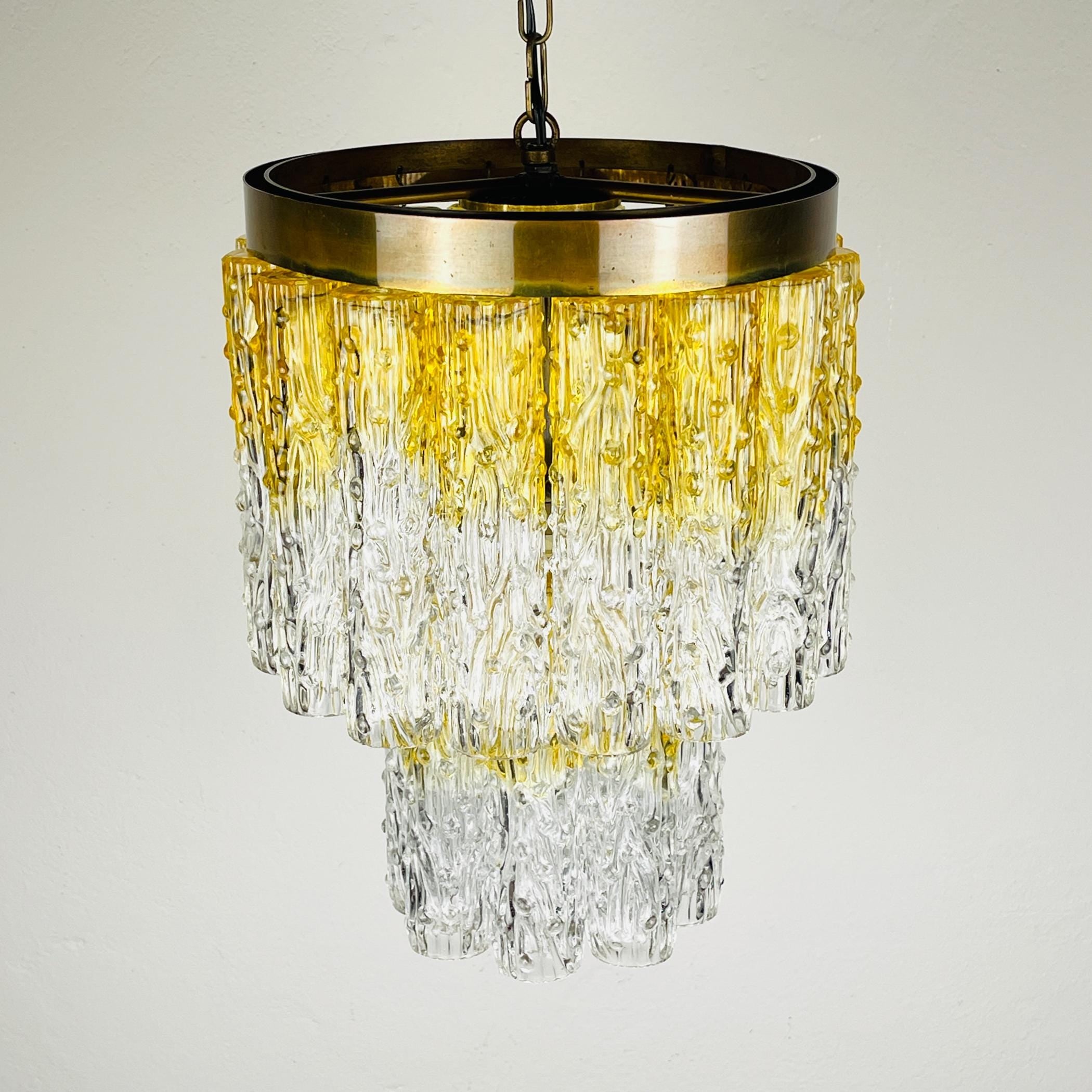 Chandelier with gold and clear glass design on a light gray background