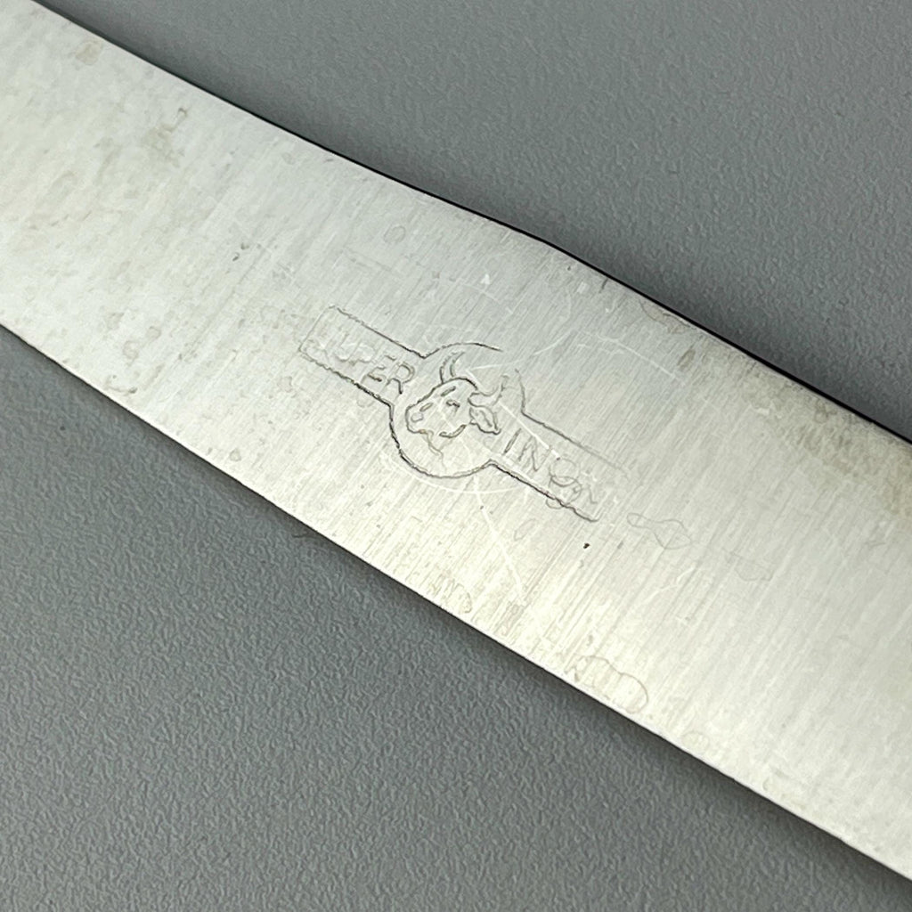 Close-up of a 800 silver vintage knife with a brand logo, made in Italy in 1960s