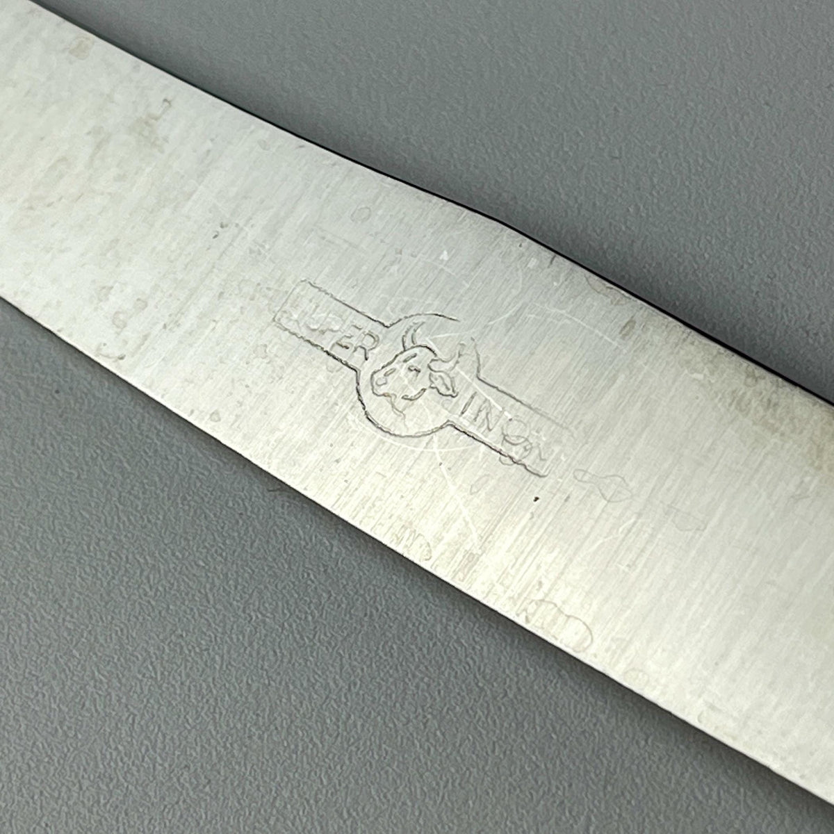 Close-up of a 800 silver vintage knife with a brand logo, made in Italy in 1960s