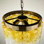 Gold and clear chandelier with textured design on a neutral background
