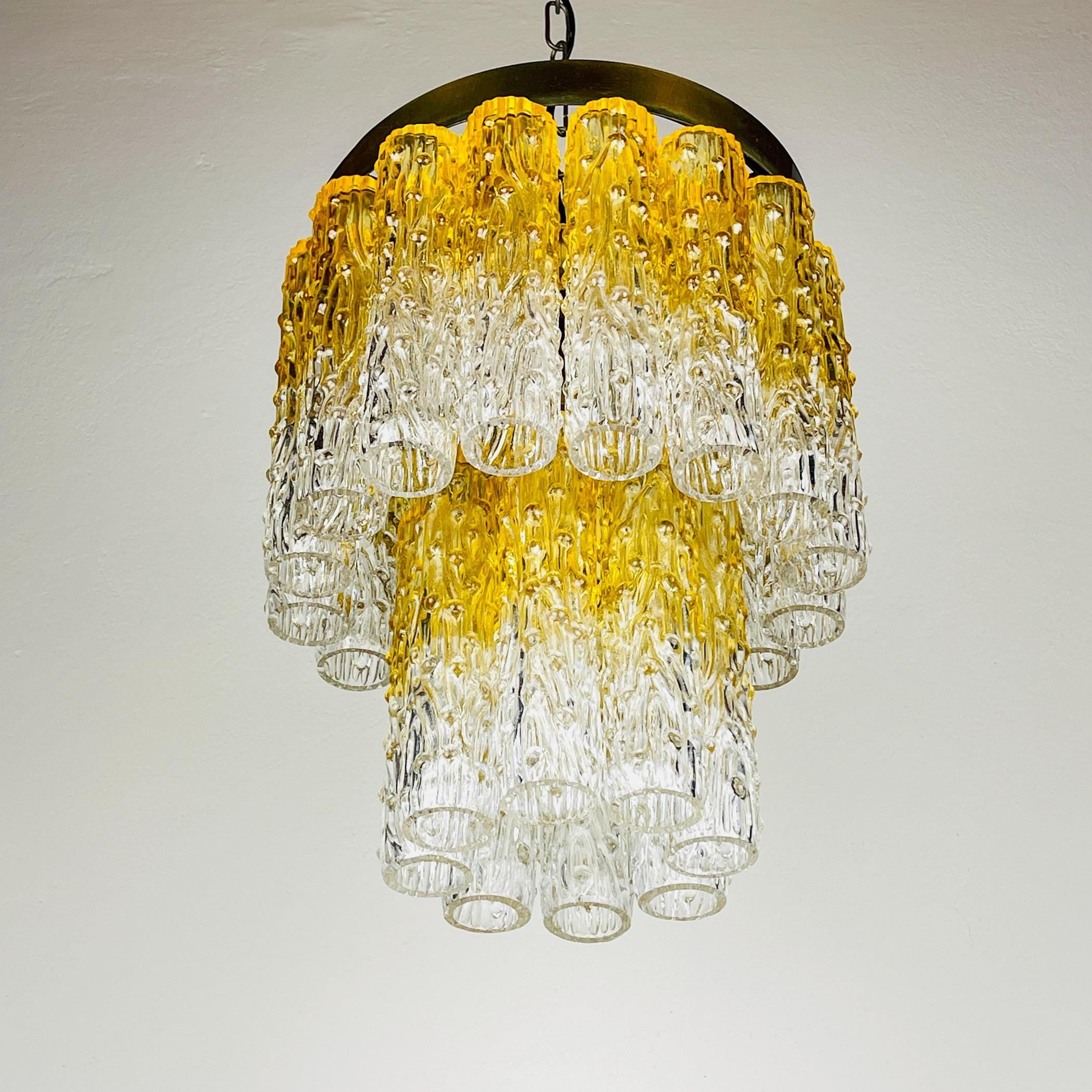 Chandelier with yellow and clear glass tubes on a white background