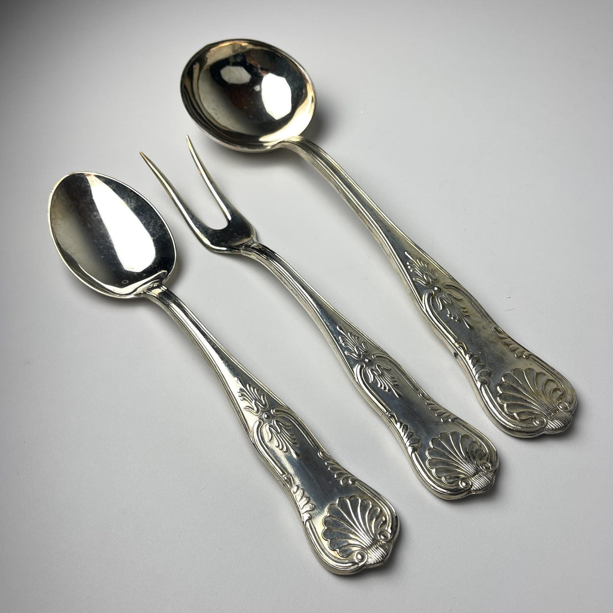 Vintage set of Italian 800 silver spoons and a fork on a gray background from 1960s