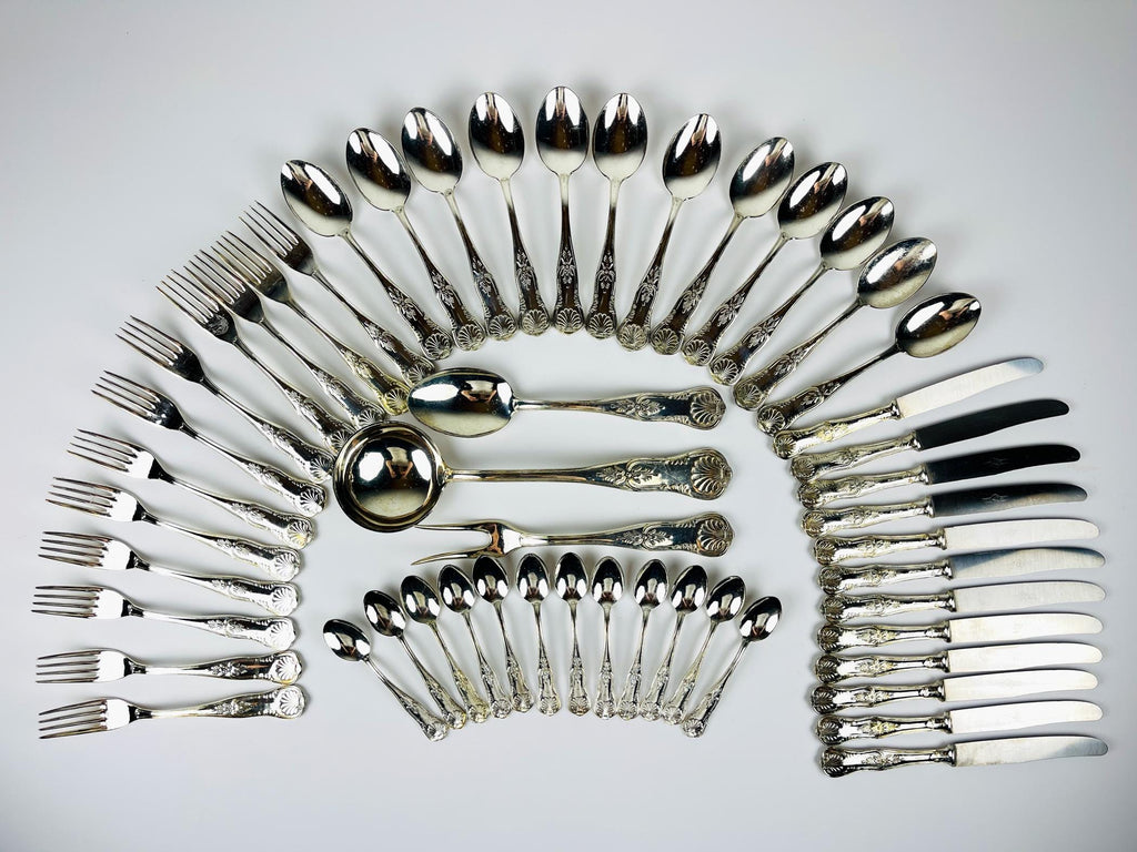 Antique 800 silver cutlery set arranged in a circular pattern on a light gray background, Italian vintage from 1960s