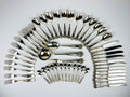 Antique 800 silver cutlery set arranged in a circular pattern on a light gray background, Italian vintage from 1960s