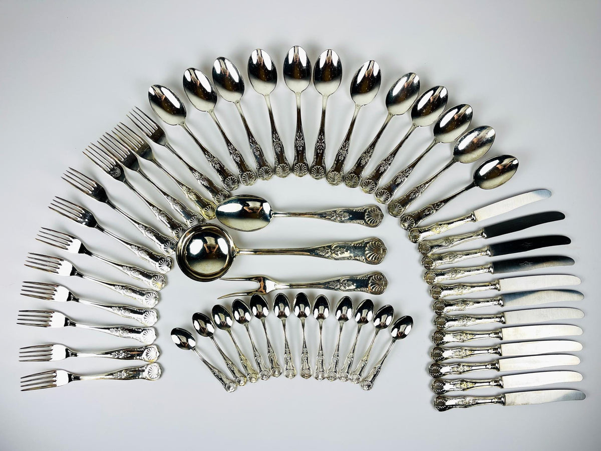 Antique 800 silver cutlery set arranged in a circular pattern on a light gray background, Italian vintage from 1960s