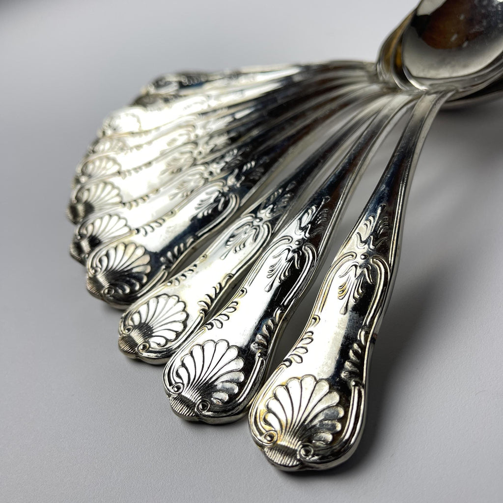 Vintage set of 800 silver spoons with detailed patterns on a gray background made 1960s